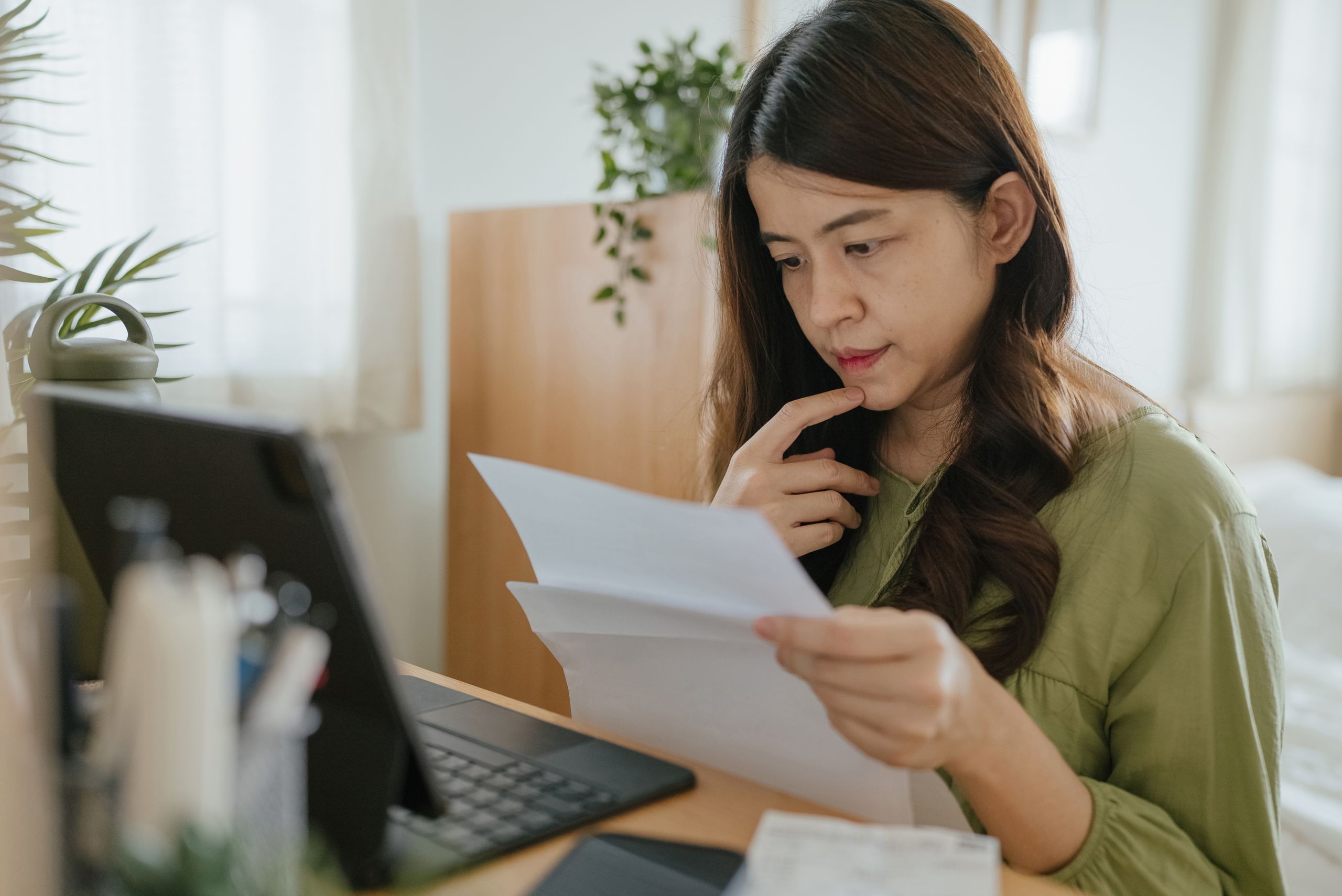 Mother Using Laptop To Check Finances At Home.